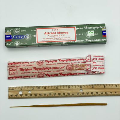 disassembled satya hand rolled attract money incense with ruler for size reference