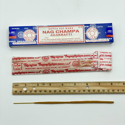 disassembled satya hand rolled NAG CHAMPA incense with ruler for size reference
