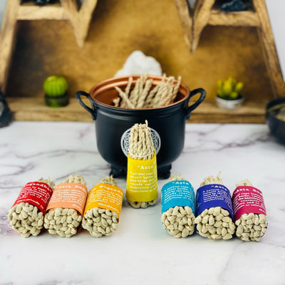 one standing Asta Sugandha rope incense bundle surrounded by other bundles that are laying down