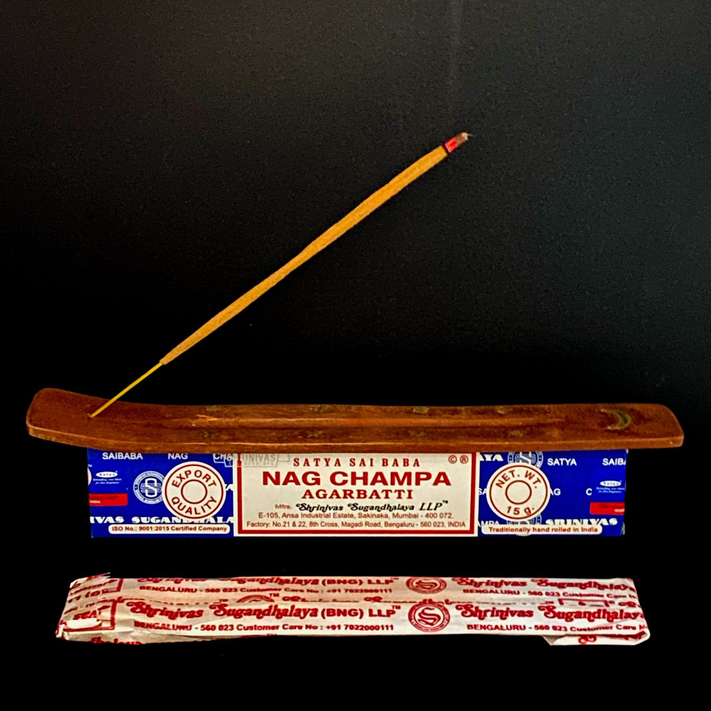 satya hand rolled NAG CHAMPA incense burning on display