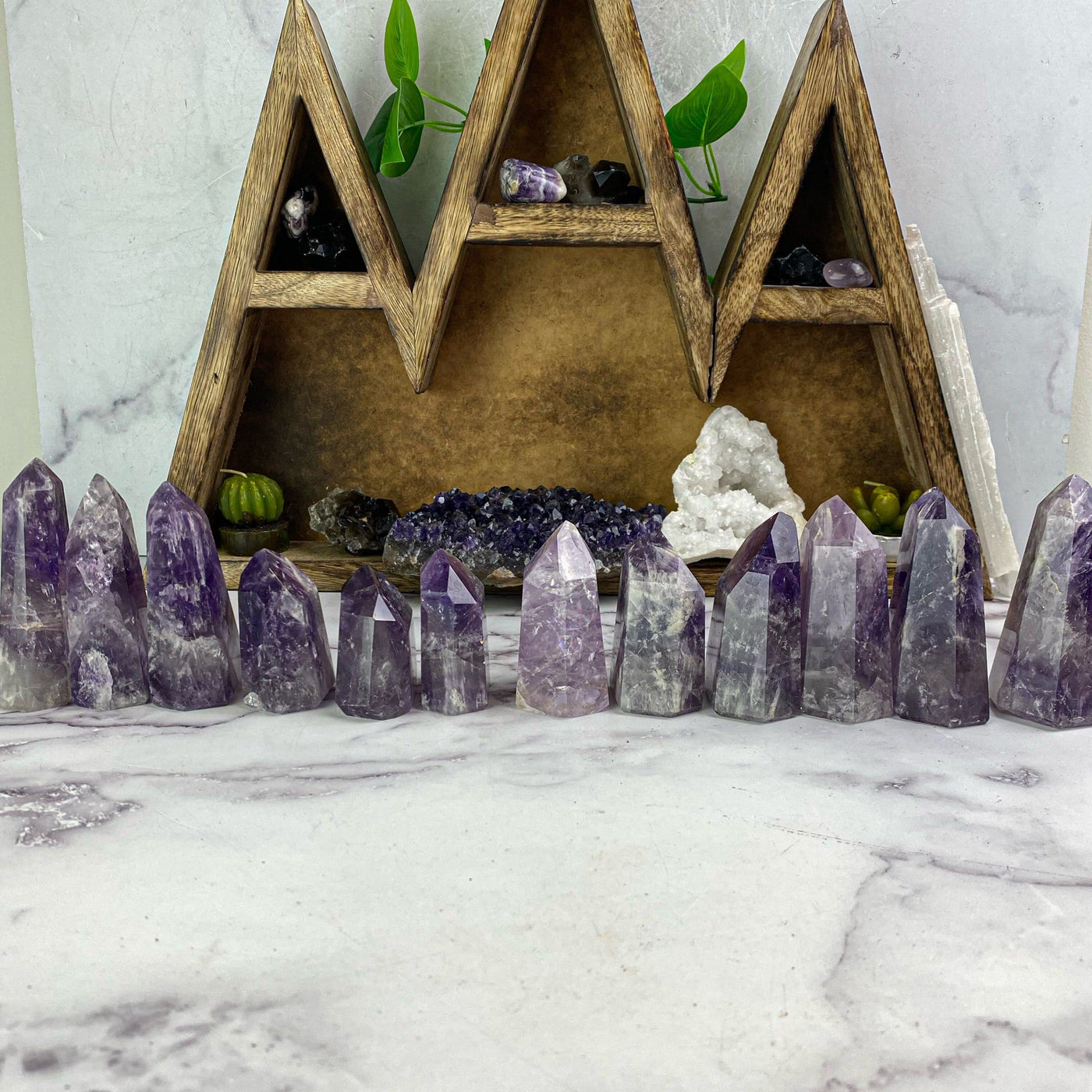 polished amethyst points lined up to show various heights