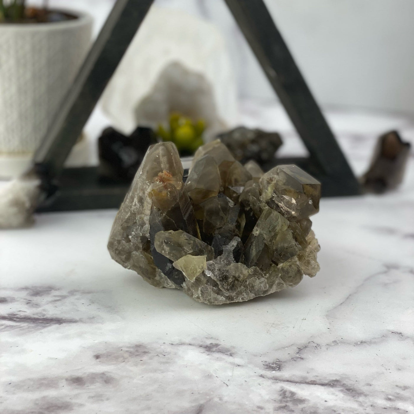 natural smokey quartz cluster on display