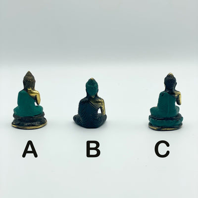 back view of 3 different Buddha mini statues on white background