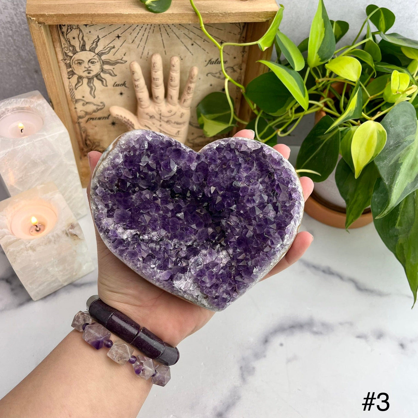 Druzy Purple Amethyst Hearts Top view of choice number three with hand for size reference 