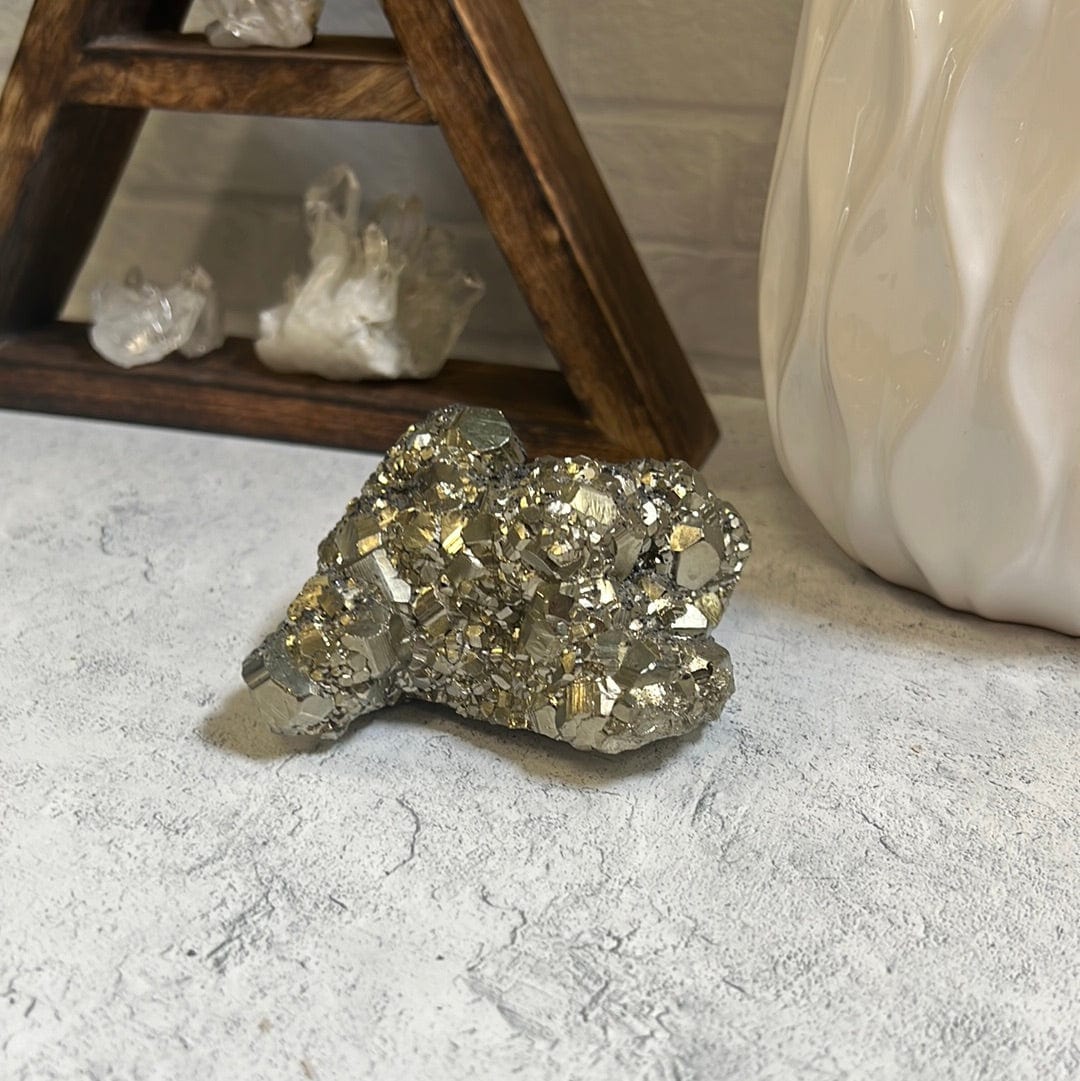Pyrite cluster on a gray background.