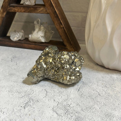 Pyrite cluster on a gray background.
