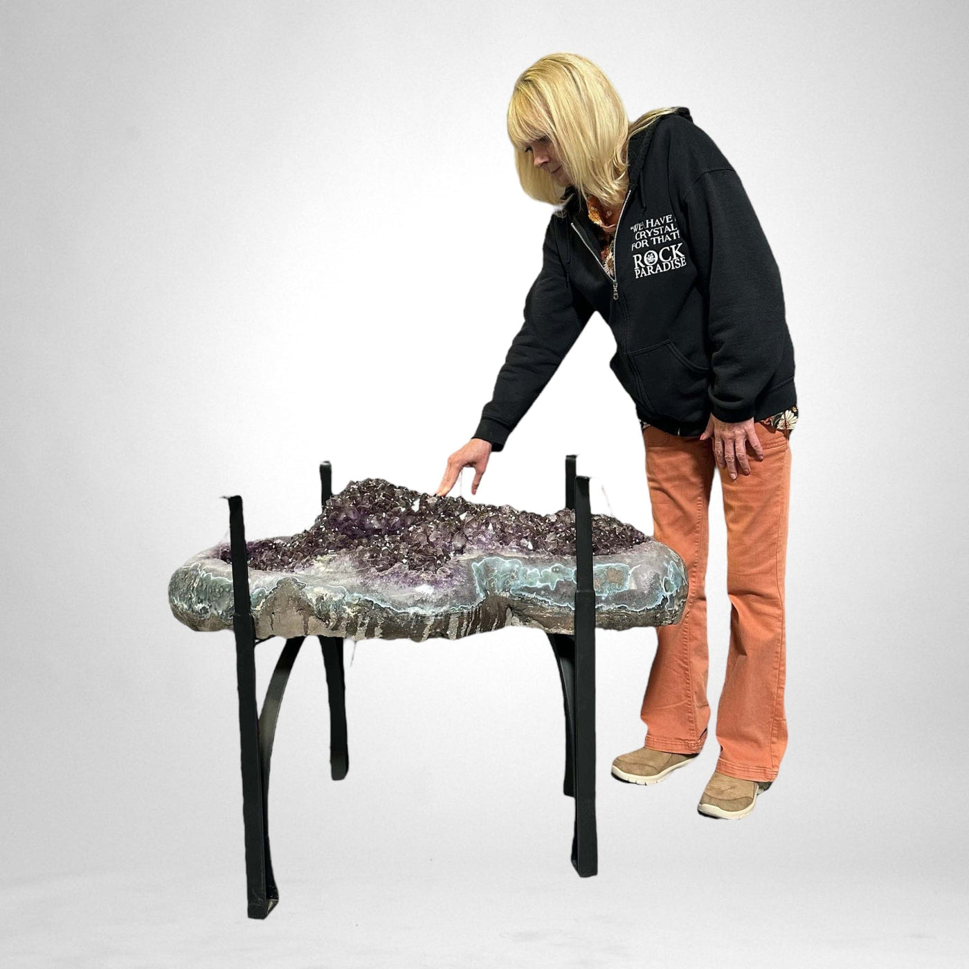 woman standing next to Amethyst Crystal Cluster Geode Table on Metal Base 