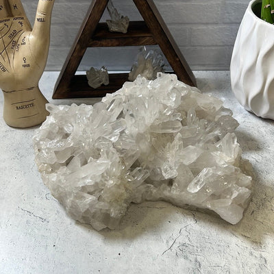 Large crystal quartz cluster on a cement background.