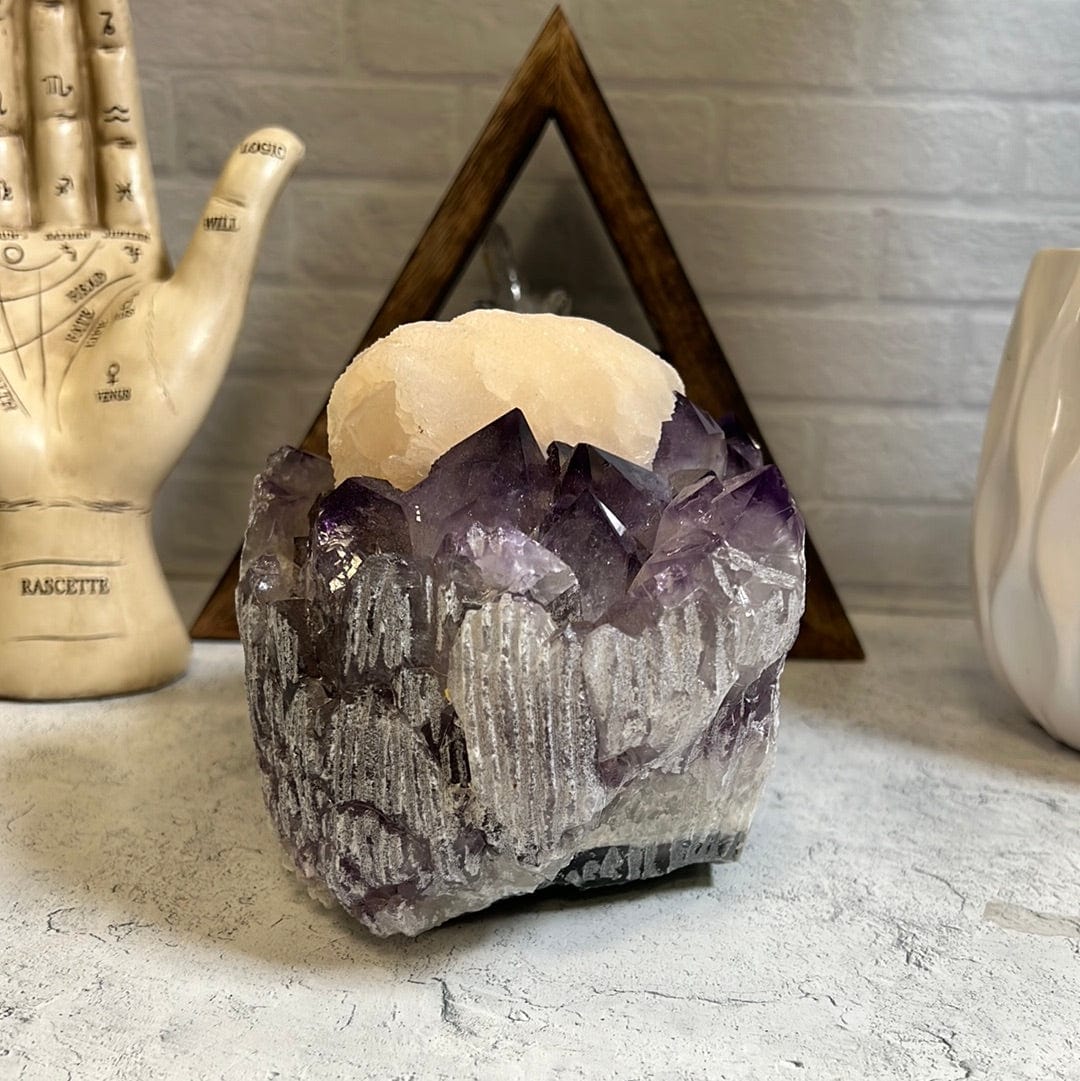 Large high quality purple amethyst cluster with a large cream color calcite formation around the center of it.