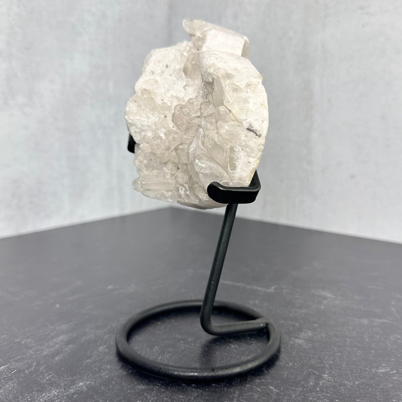 Left profile view of Crystal Quartz Abstract Heart on Metal Stand.