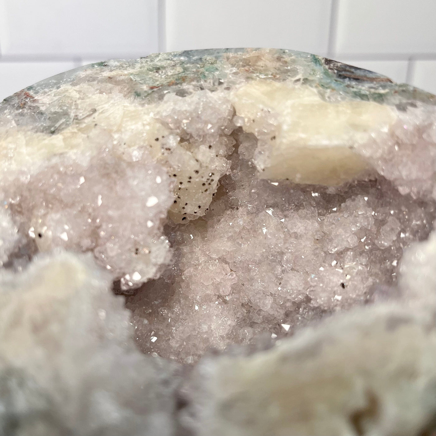 Up close view of druzy and calcite formations inside the top piece of Amethyst Druzy Geode Box.