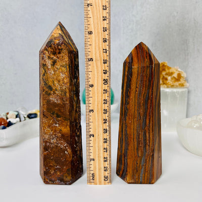 Tigers Eye Towers front facing, with a ruler in between them for size reference.