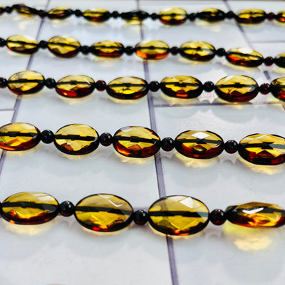 Up close view of Baltic Amber Beaded Necklaces, lined up next to each other.