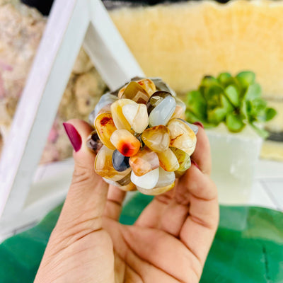 Up close view of bottom end of Agate Stone Grape Bunch with Silver Leaf, held up in hand