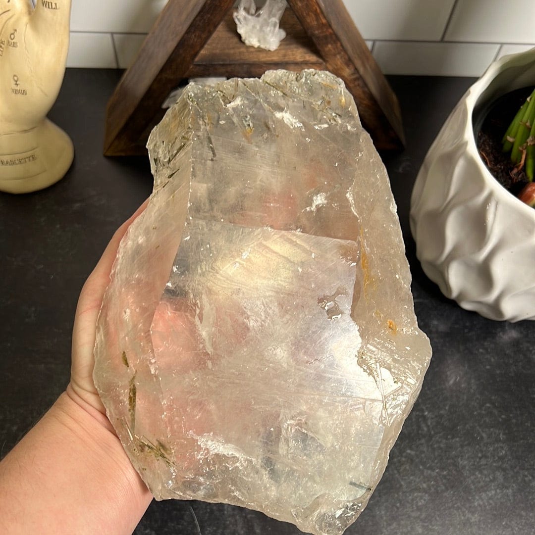 Large freeform clear crystal quartz formation with epidote in the top and a few lines of epidote at the bottom.