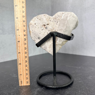 Back view of Crystal Quartz Abstract Heart on Metal Stand next to a ruler for size reference.