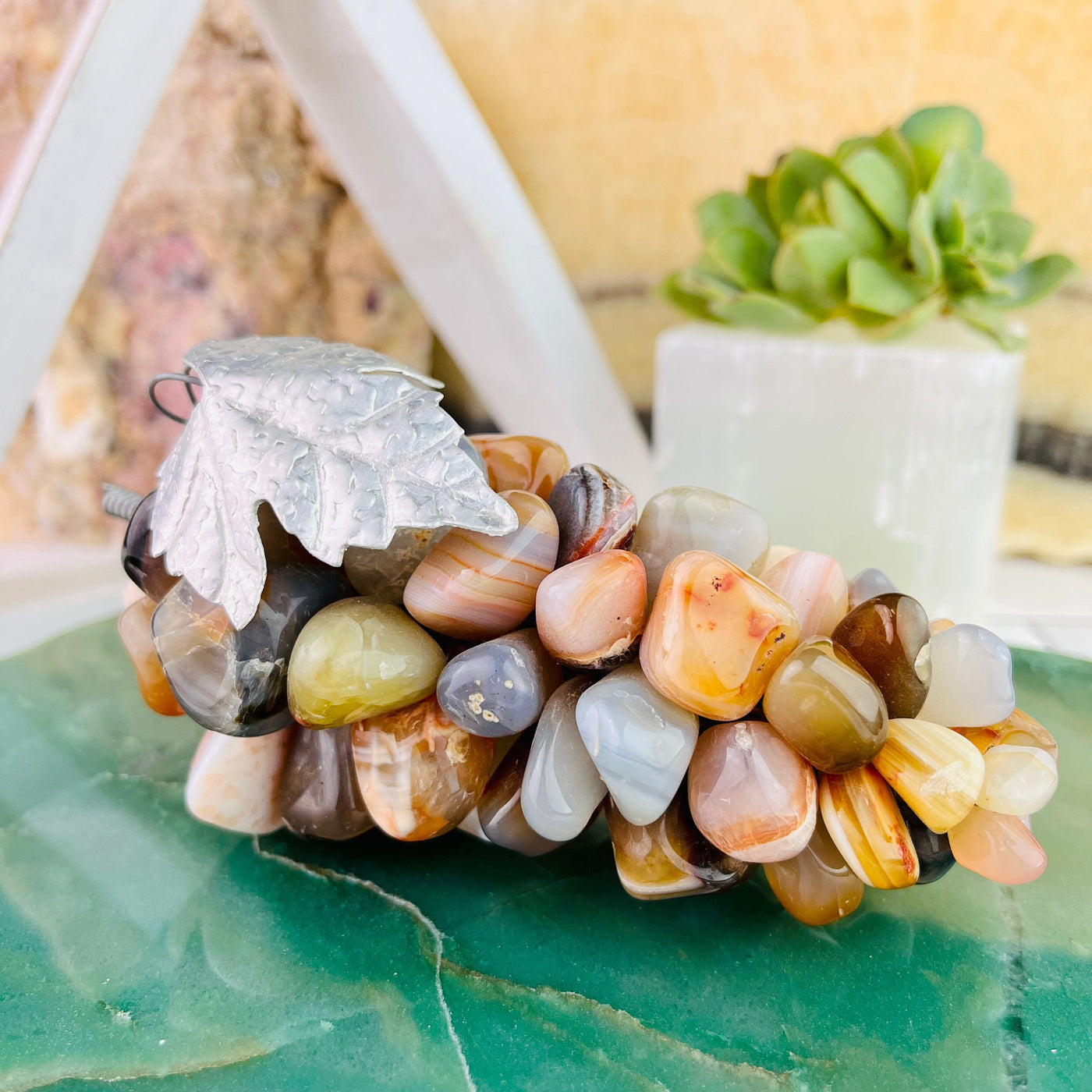 Up close frontal view of Agate Stone Grape Bunch with Silver Leaf, stem facing to the left
