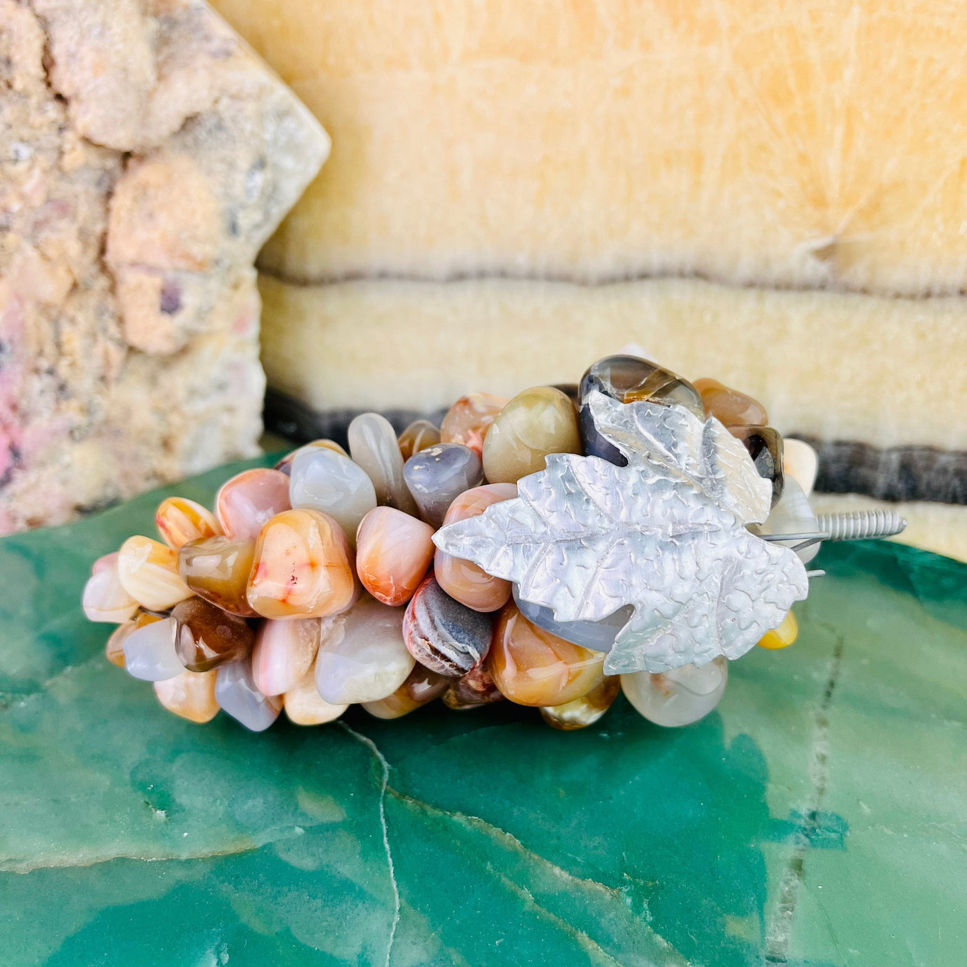 Frontal view of Agate Stone Grape Bunch with Silver Leaf, stem facing to the right