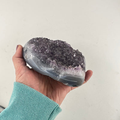 Amethyst Crystal Cluster Heart in a hand showing side view and thickness of stone
