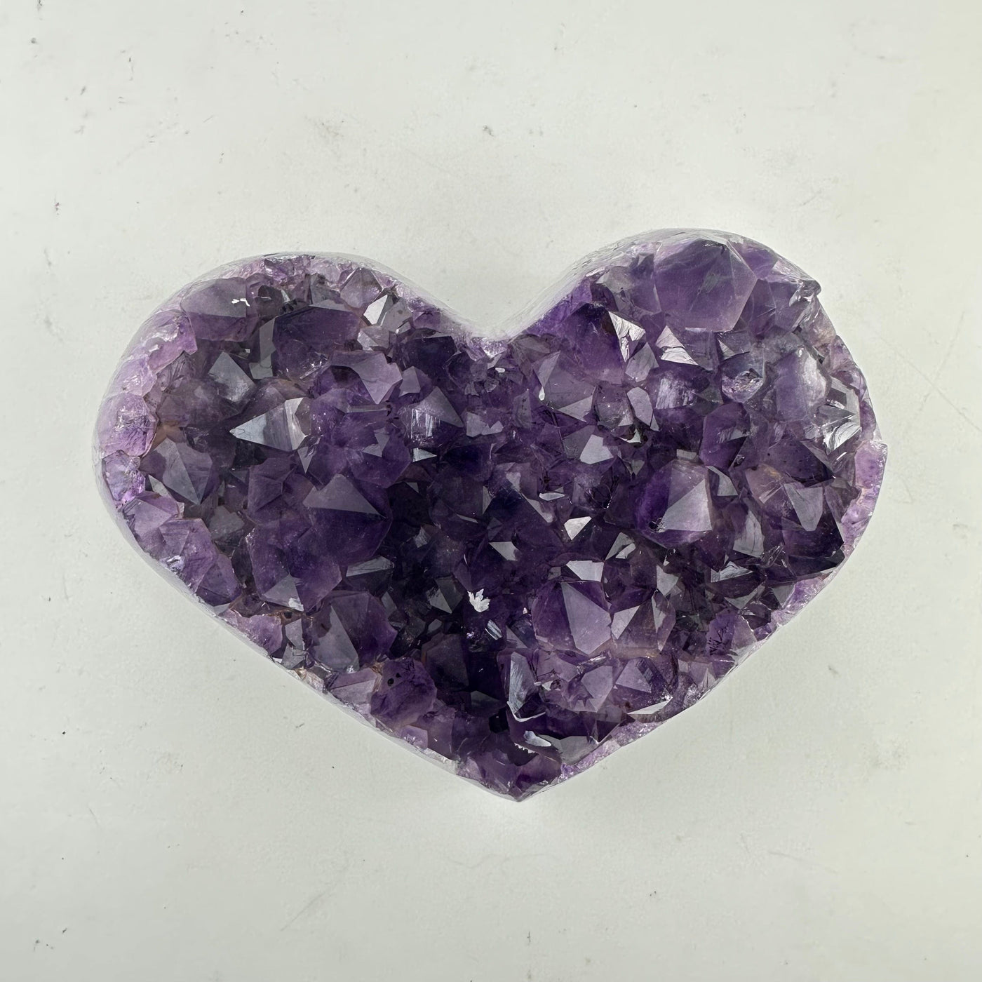 Amethyst Crystal Cluster Heart on white table