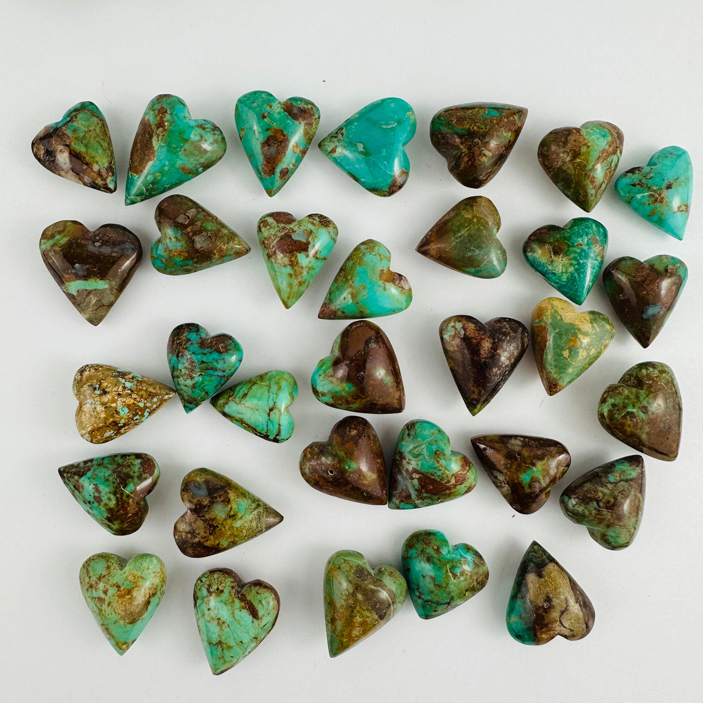 Turquoise Hearts spread out on a table showing colors and size variations for the stock on hand