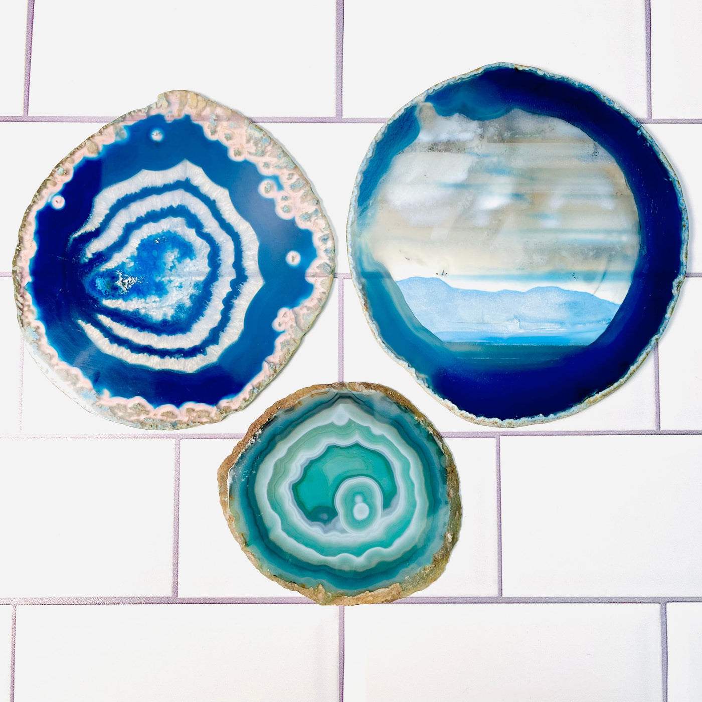 Set of 3 Agate Slices - Dyed Blue and Green, displayed on a tile surface.
