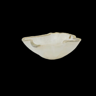 Light colored Mexican onyx bowl on a black background.