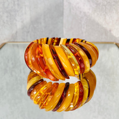 Frontal view of Baltic Amber Bracelet, on a mirrored surface.