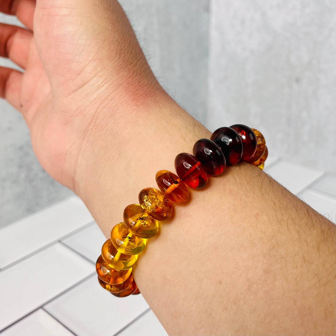 Up close view of Baltic Amber Bracelet on a man's wrist.