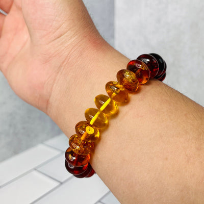 Up close view of Baltic Amber Bracelet on a man's wrist.