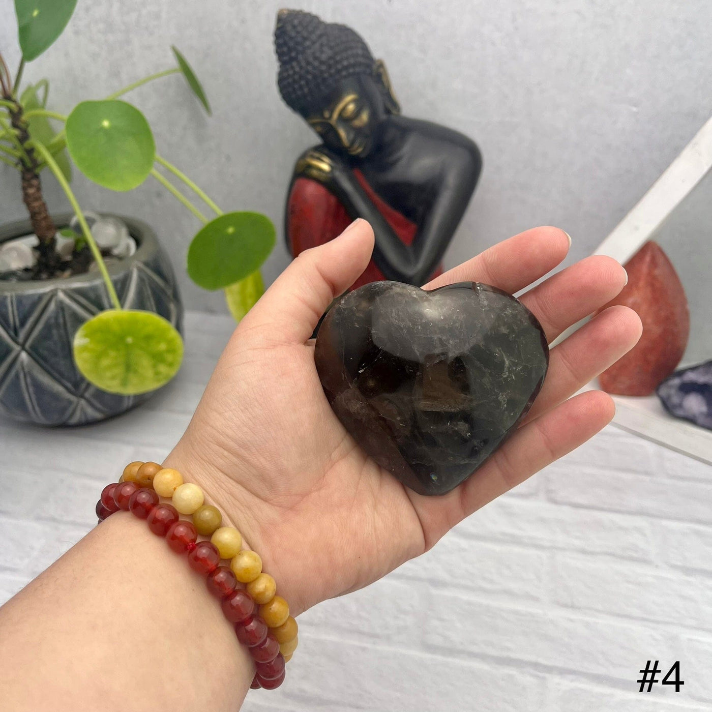 Smokey Quartz Polished Puff Hearts - front view of choice number four in hand for size reference