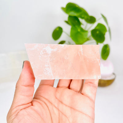 View of long side of Pink Calcite Oblique Rectangular Prism in hand