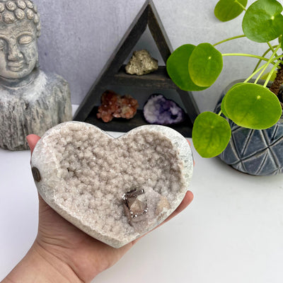 Natural Druzy Agate Heart With Calcite Formation with hand for size reference 