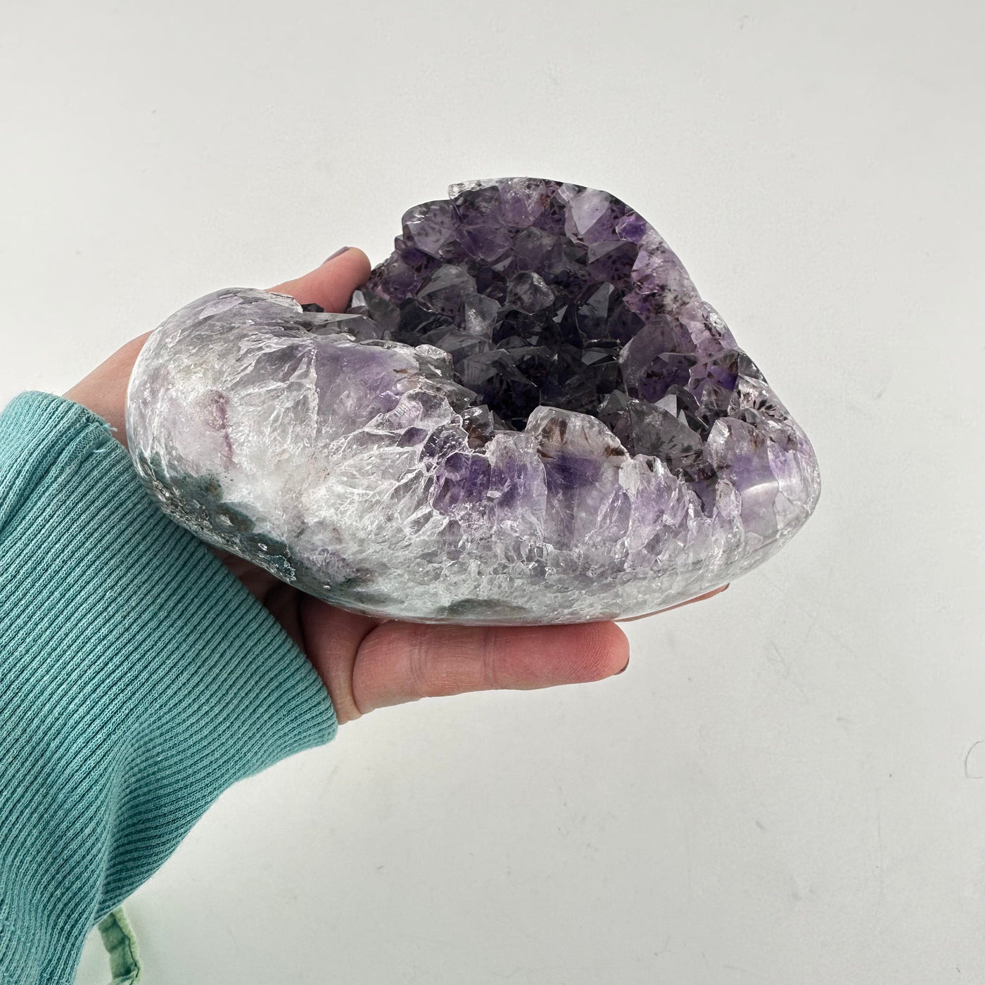 Amethyst Crystal Cluster Heart in a hand showing side view