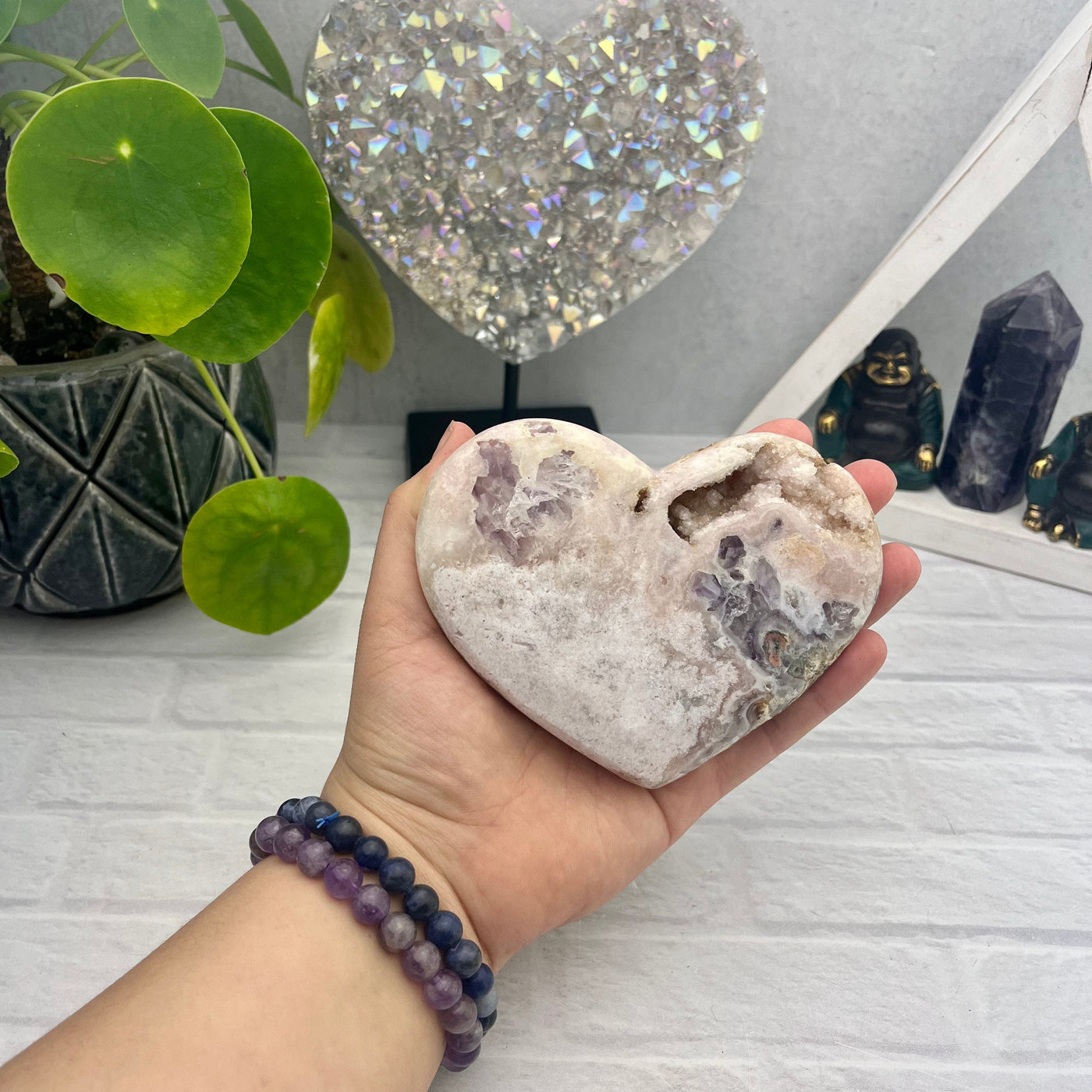 Amethyst pink heart - top view with hand for size reference 