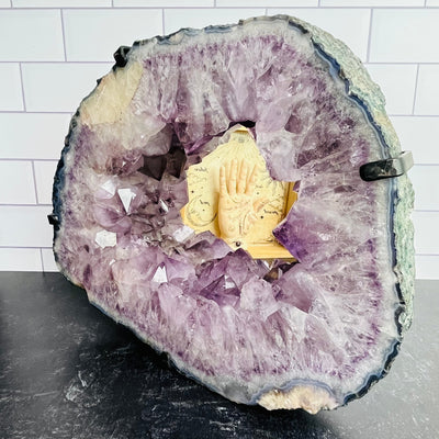 Frontal view of Amethyst Cluster with Calcite Mirror, propped up on a flat surface