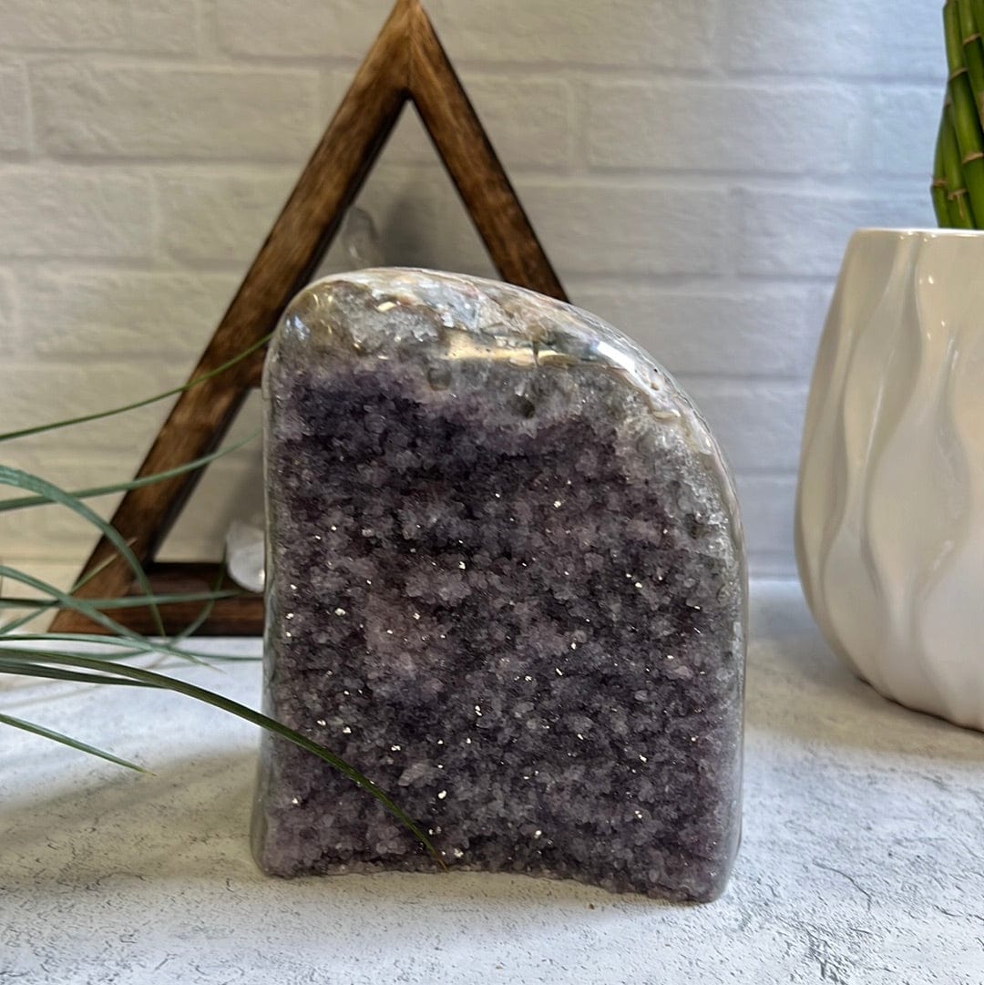 Amethyst cluster plant holder without a plant inside showing it's purple clusters.