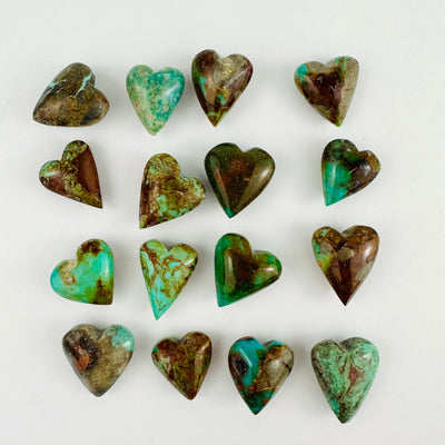 Assorted turquoise hearts on a white background.