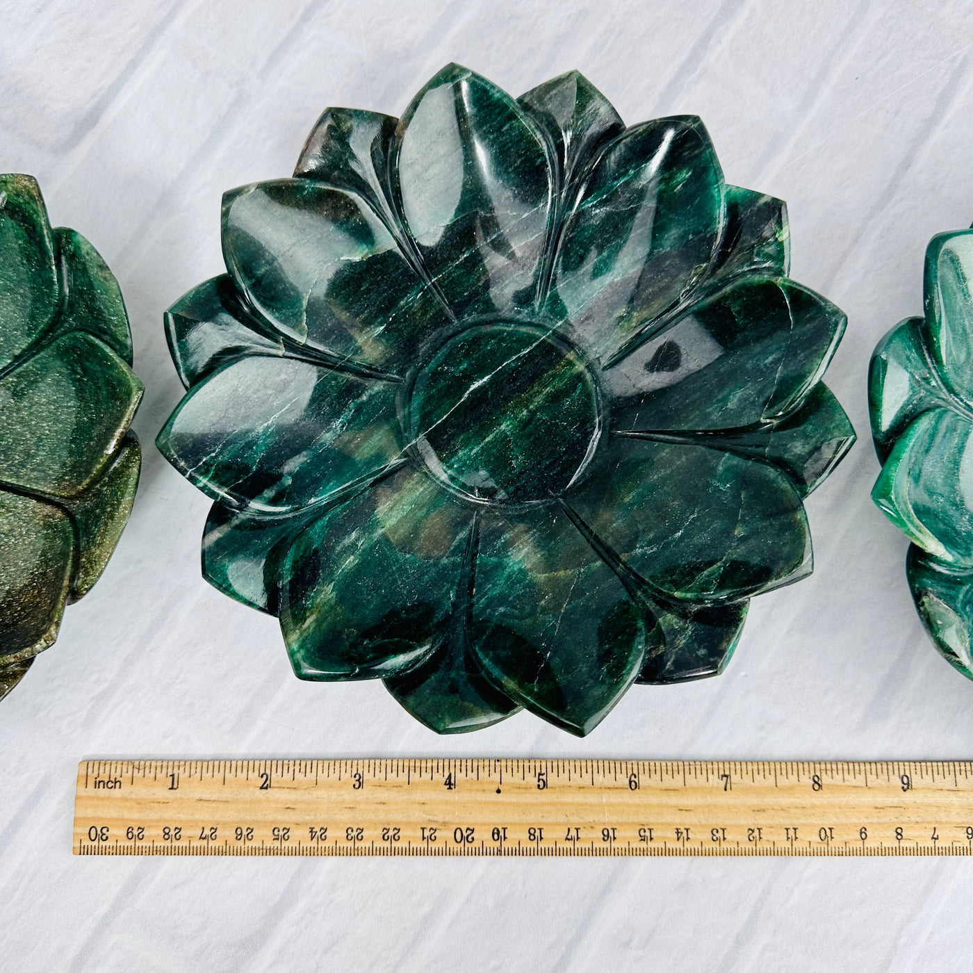 Green Quartz Lotus Bowl next to a ruler for size reference.