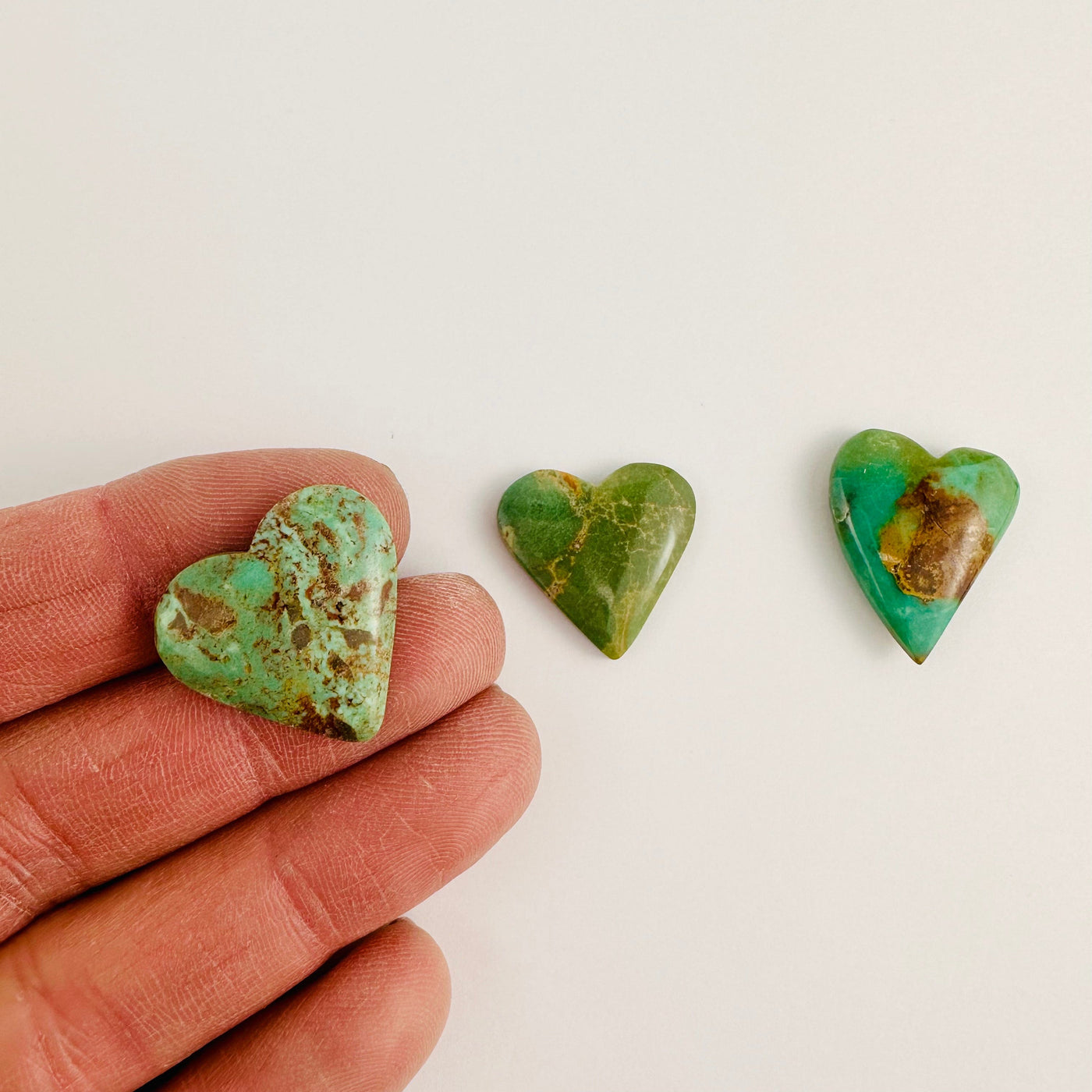 3 Turquoise Heart Cabochons, with 1 in a hand for size reference