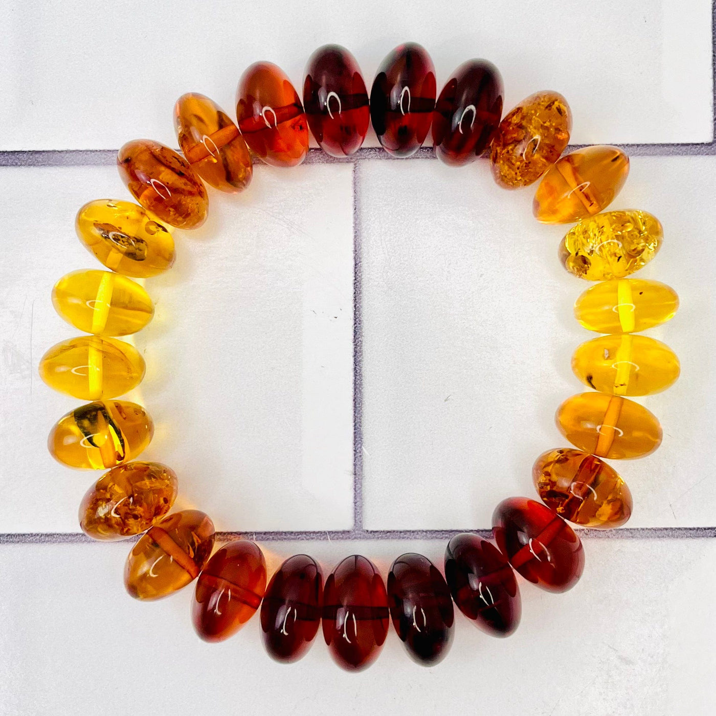 Aerial view of Baltic Amber Bracelet on a tile surface.