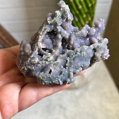 hand holding up Grape Agate Botryoidal Purple Chalcedony Formation