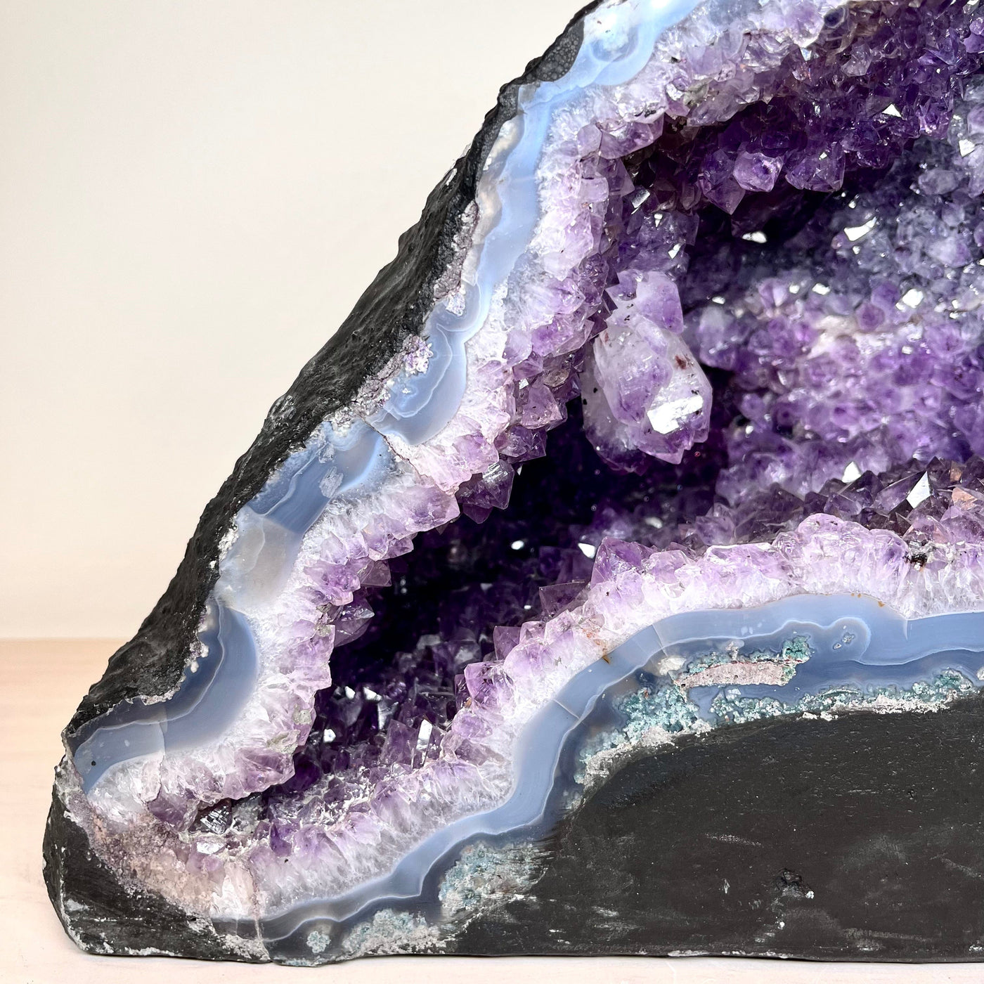 Up close view of bottom left part of the face of Amethyst Cluster Geode Cave.