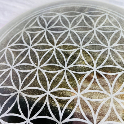 Up close view of Flower of Life pattern on Gold Sheen Obsidian Plate..