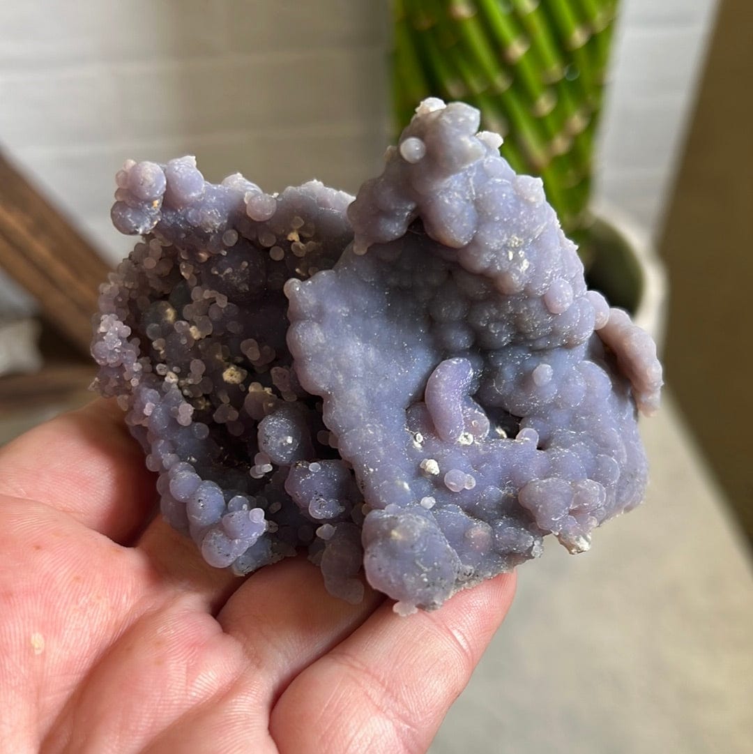 hand holding up Grape Agate Botryoidal Purple Chalcedony Formation