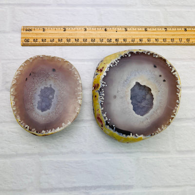 Speckled Agate Druzy Geode Box opened up on a white surface placed beside a ruler for length reference.
