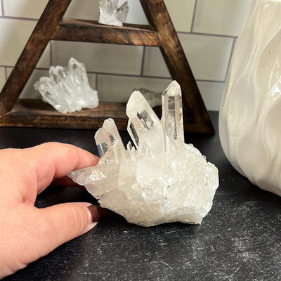Crystal cluster with a woman's hand next to it