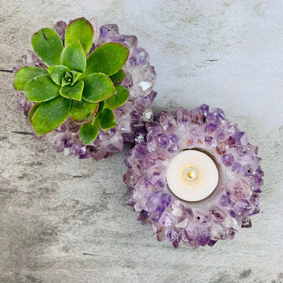 Amethyst Point Candle Holders on a table, one has a candle and one has a plant