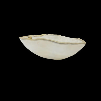 Light colored Mexican onyx bowl on a black background.