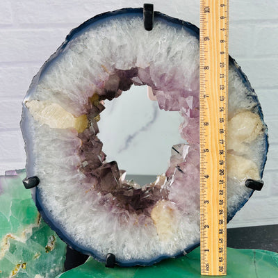 Frontal view of Amethyst Cluster Mirror with Calcite, next to ruler for size reference